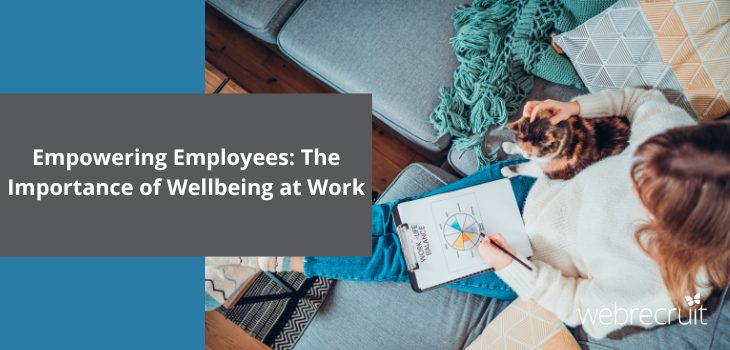 The title 'Empowering Employees: The Importance of Wellbeing at Work' with a background image of a woman sitting on a sofa, taking notes with a cat on her lap.